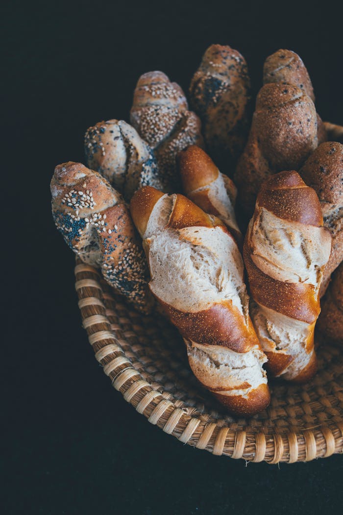 services-02 A top view of a basket filled with various freshly baked baguettes, perfect for food photography enthusiasts.